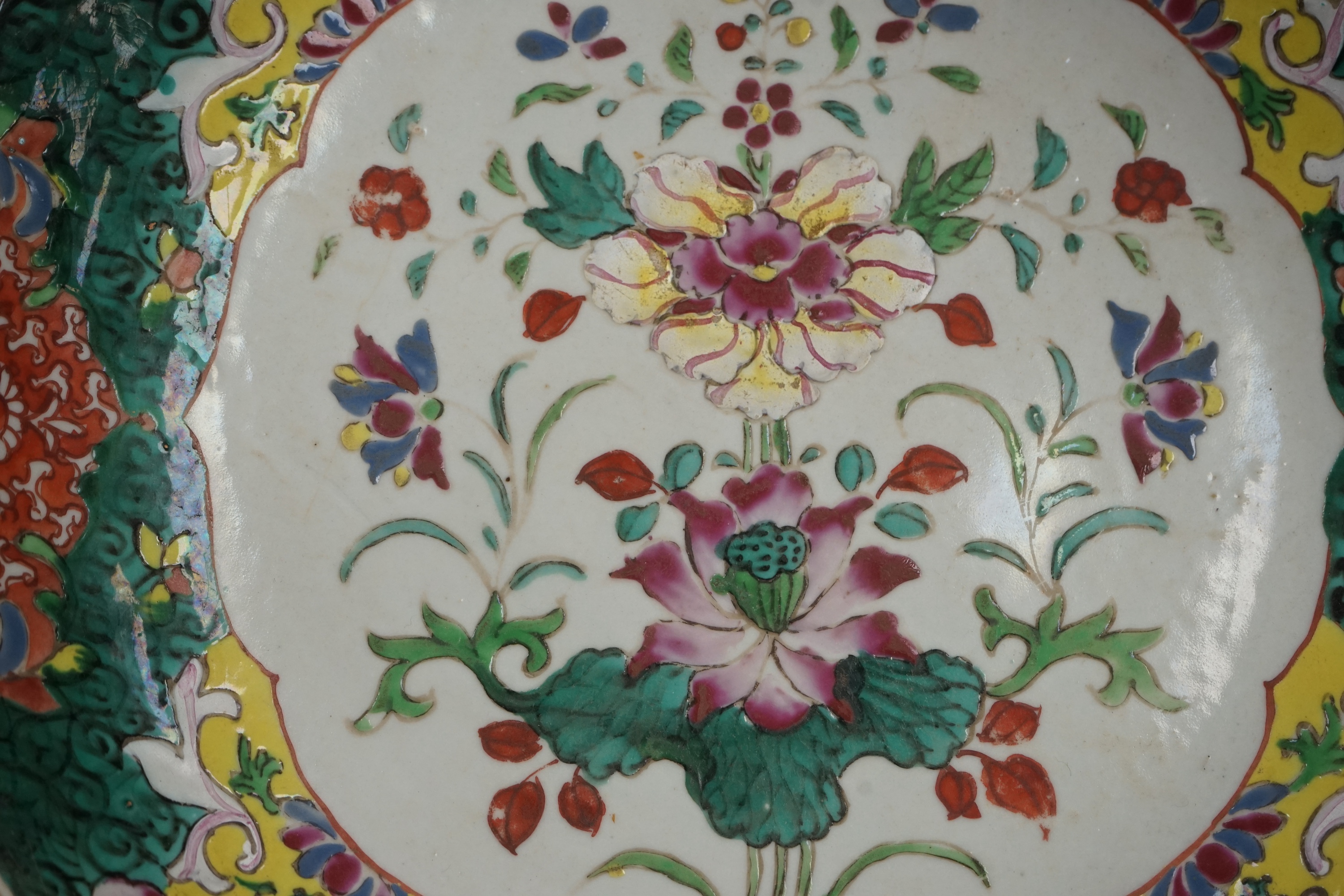 A Chinese straits famille rose dish, 19th century, 33cm diameter. Condition - crack to base